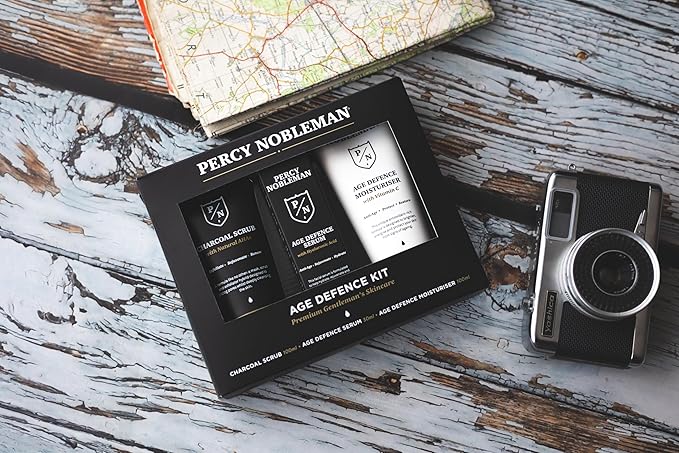 Age Defence Kit, a men's skincare set containing Charcoal Face Scrub (with Natural AHAs), ultra-hydrating Facial Serum (with Hyaluronic Acid), and Moisturiser (with Vitamin C)